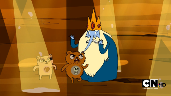 Ice King being menaced by a brown scruffy teddy bear with stubble (somehow) while a lighter bear with long eyelashes and a heart symbol stands behind.