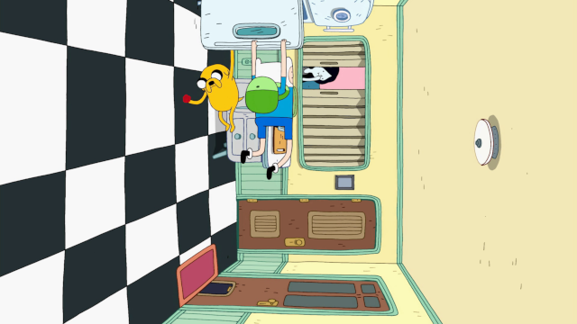 Finn and Jake hang from the open door of a fridge in a room where gravity appears to be at right angles to normal. The camera is aligned with them, so it's as if Marceline (in the background) is sitting on a wall.