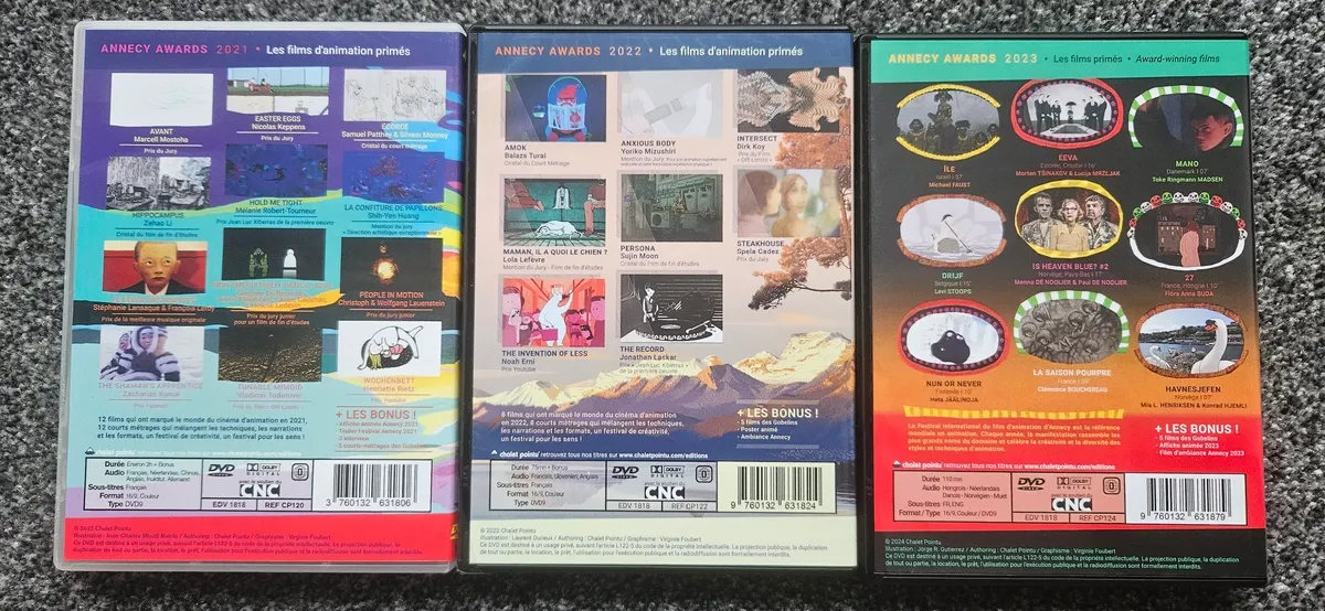 Photo of the backs of the three DVDs showing the varous short films on them.