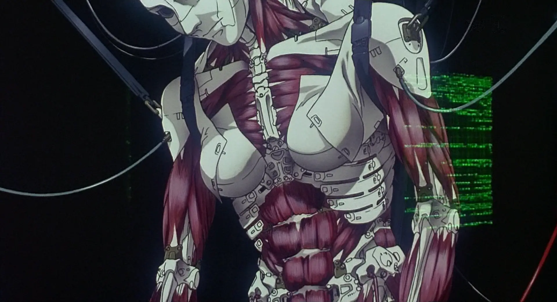 Still from GitS. A cyborg body hangs suspended in the process of construction.
