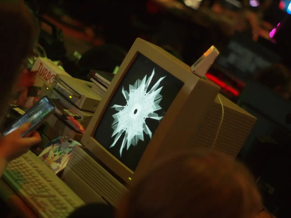 A demo being played on an old Apple computer, to create a symmetric pattern of white lines.