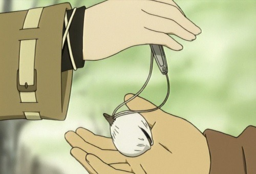 Still from Haibane Renmei showing a closeup of two characters' outstretched hands. The character on the left is dropping a small bell into the hand of the character on the right.