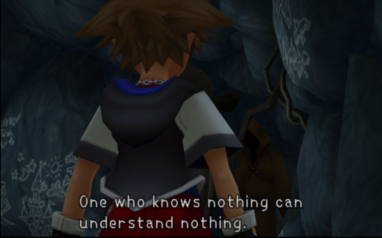 Sora, a boy in a short-sleeved jacket with spiky brown hair, facing away from the camera in a dark cave. A subtitle reads 'One who knows nothing can understand nothing.'