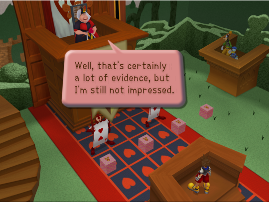 A courtroom presided over by a large woman dressed in red and black, with a grid of hearts and anthropomorphic-playing-card guards. Sora stands opposite on a stand.
