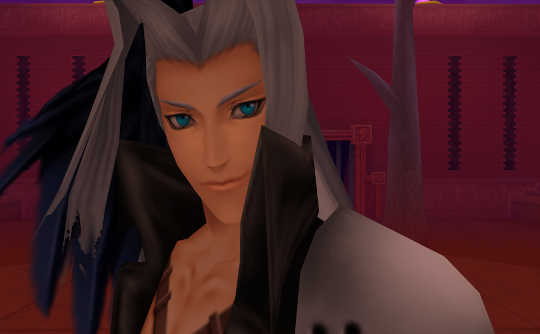 A close-up of Sephiroth, the villain of Final Fantasy 7. He has one angel wing, pale skin, and long white hair with two oddly angled locks hanging in front of his face.