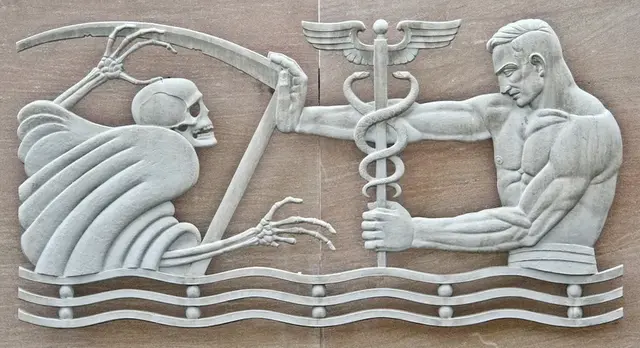 Bas-relief mural on the wall of a hospital showing the a medic pushing back the Grim Reaper with the Rod of Asclepius.