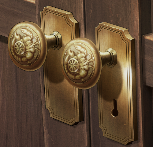 A cropped image of two doorhandles engraved with an image of a scorpion and a wheel.